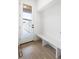 A bright entryway features wood floors, a bench, and a door that looks to the outside at 1953 W 47Th Ave, Denver, CO 80211