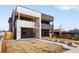 Modern two-story home boasts a sleek design with brick accents, balconies, and minimalist landscaping at 1953 W 47Th Ave, Denver, CO 80211