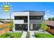 Modern two-story duplex featuring unique black and white facade, manicured front yard, and available incentives at 1953 W 47Th Ave, Denver, CO 80211