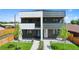 Modern townhome with manicured front yard, contrasting paint, and eye-catching curb appeal at 1953 W 47Th Ave, Denver, CO 80211