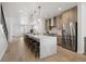 Bright kitchen features a large island with seating, stainless steel appliances, and modern cabinets at 1953 W 47Th Ave, Denver, CO 80211
