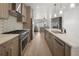 Open-concept kitchen featuring stainless steel appliances, a large island, and a modern design at 1953 W 47Th Ave, Denver, CO 80211