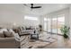 Bright living room features a modern ceiling fan and sliding doors to the backyard at 1953 W 47Th Ave, Denver, CO 80211