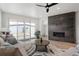 Bright living room features a modern fireplace, ceiling fan, and sliding doors to the backyard at 1953 W 47Th Ave, Denver, CO 80211
