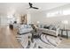 Open-concept living room boasts a ceiling fan and flows into a stylish, modern kitchen at 1953 W 47Th Ave, Denver, CO 80211