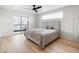 The bright, spacious main bedroom features a ceiling fan and outdoor balcony at 1953 W 47Th Ave, Denver, CO 80211