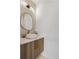 Chic powder room with a unique vanity, modern mirror, and stylish lighting fixture at 1953 W 47Th Ave, Denver, CO 80211