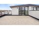 Large rooftop deck featuring tile flooring and sliding glass doors providing access to indoor living areas at 1953 W 47Th Ave, Denver, CO 80211