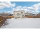 Spacious backyard with patio, and snow-covered lawn at 20242 E Lasalle Pl, Aurora, CO 80013