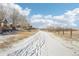 A snow-covered path winds through the community landscape at 20242 E Lasalle Pl, Aurora, CO 80013