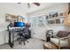 Bright home office features a large desk, comfortable chair, and ample shelving at 20242 E Lasalle Pl, Aurora, CO 80013