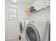 Laundry room with washer, dryer, and shelving for storage at 20242 E Lasalle Pl, Aurora, CO 80013