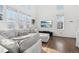 Bright living room featuring an L-shaped sofa and hardwood floors at 20242 E Lasalle Pl, Aurora, CO 80013