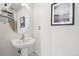 Small powder room with pedestal sink and oval mirror at 20242 E Lasalle Pl, Aurora, CO 80013