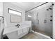 Bright bathroom featuring a standalone tub and glass enclosed shower with modern fixtures at 3409 Navajo St, Denver, CO 80211
