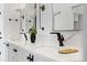 Modern bathroom featuring dual sinks, sleek black fixtures, and stylish marble countertops at 3409 Navajo St, Denver, CO 80211