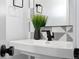 A modern bathroom features a white sink, black faucet, and geometric tile accent wall at 3409 Navajo St, Denver, CO 80211