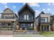 Modern two-story home with a striking dark exterior, balcony, and manicured front yard at 3409 Navajo St, Denver, CO 80211