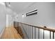 Hallway with wood floors, modern railing, and natural light from transom window, adding architectural interest at 3409 Navajo St, Denver, CO 80211