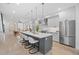 This modern kitchen has an open floor plan with an island, stainless steel appliances, and dining area at 3409 Navajo St, Denver, CO 80211