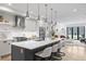 Modern kitchen featuring a large island with seating, stainless steel appliances, and stylish pendant lighting at 3409 Navajo St, Denver, CO 80211