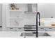 Close-up of a modern kitchen sink with stylish faucet, quartz countertop, and white subway tile backsplash at 3409 Navajo St, Denver, CO 80211
