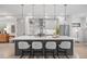 A bright kitchen features a large island with seating, modern appliances and pendant lighting at 3409 Navajo St, Denver, CO 80211
