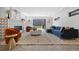 Stylish living room with modern fireplace, designer furniture, and glass doors to the outdoor space at 3409 Navajo St, Denver, CO 80211