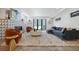 Spacious living room with a modern fireplace, plush rug, and access to outdoor space through sliding doors at 3409 Navajo St, Denver, CO 80211