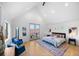 Vaulted main bedroom with natural light, a balcony and an en suite bathroom offers a private retreat at 3409 Navajo St, Denver, CO 80211