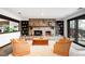 Cozy basement featuring a stone fireplace, built-in bookshelves, plush seating, and sliding glass doors at 6389 S Monaco Ct, Centennial, CO 80111