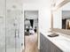 Modern bathroom with dual sink vanity, marble walk-in shower, and contemporary fixtures at 6389 S Monaco Ct, Centennial, CO 80111