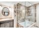Bathroom featuring granite countertop, a vessel sink, soaking tub behind glass, and decorative wall art at 6389 S Monaco Ct, Centennial, CO 80111