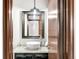 Stylish powder room with vessel sink, granite countertop, modern faucet, decorative mirror, and wood trim at 6389 S Monaco Ct, Centennial, CO 80111