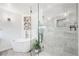 Elegant bathroom boasts a freestanding tub and glass-enclosed shower with marble tile at 6389 S Monaco Ct, Centennial, CO 80111