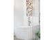 Contemporary bathtub features modern faucet and marble-tiled glass enclosed shower at 6389 S Monaco Ct, Centennial, CO 80111