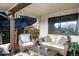 Cozy outdoor deck with comfortable seating area under an umbrella at 6389 S Monaco Ct, Centennial, CO 80111