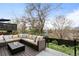 Outdoor deck with comfortable sectional, fire pit, and landscaping views at 6389 S Monaco Ct, Centennial, CO 80111