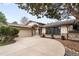 Home exterior featuring an attached two-car garage and a circular driveway at 6389 S Monaco Ct, Centennial, CO 80111