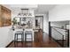 Open kitchen with granite countertops, stainless steel appliances, barstool seating, and modern lighting at 6389 S Monaco Ct, Centennial, CO 80111