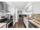Stylish kitchen featuring stainless steel appliances, stone countertops and tile backsplash at 6389 S Monaco Ct, Centennial, CO 80111
