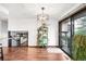 Spacious living room with hardwood floors, sliding glass doors, and modern light fixture and unique plant display at 6389 S Monaco Ct, Centennial, CO 80111