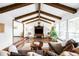 Bright living room featuring hardwood floors, exposed beams and a comfortable seating arrangement at 6389 S Monaco Ct, Centennial, CO 80111