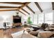 Bright living room featuring hardwood floors, exposed beams and a comfortable seating arrangement at 6389 S Monaco Ct, Centennial, CO 80111