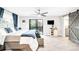 Large bedroom features a ceiling fan, barn door, and sliding glass doors to outdoor deck at 6389 S Monaco Ct, Centennial, CO 80111