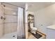 Well-lit bathroom with tiled shower and updated fixtures, complete with toilet, vanity and shelving at 4205 E 106Th Pl, Thornton, CO 80233