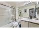 Well-lit bathroom featuring a shower over tub and a vanity with marble countertop at 4205 E 106Th Pl, Thornton, CO 80233