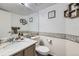 Stylish half bath featuring a marble countertop, mosaic tile accent, and decorative floating shelves at 4205 E 106Th Pl, Thornton, CO 80233