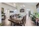 Elegant dining room with a large table, chandelier, and access to other rooms at 4205 E 106Th Pl, Thornton, CO 80233