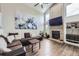 Cozy living room with a brick fireplace, comfortable seating, and vaulted ceilings at 4205 E 106Th Pl, Thornton, CO 80233
